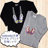 【30%OFF】cody coby（コーディーコービー）本物そっくりのスニーカーが肩から掛かった長袖シャツ ブラック90cm
